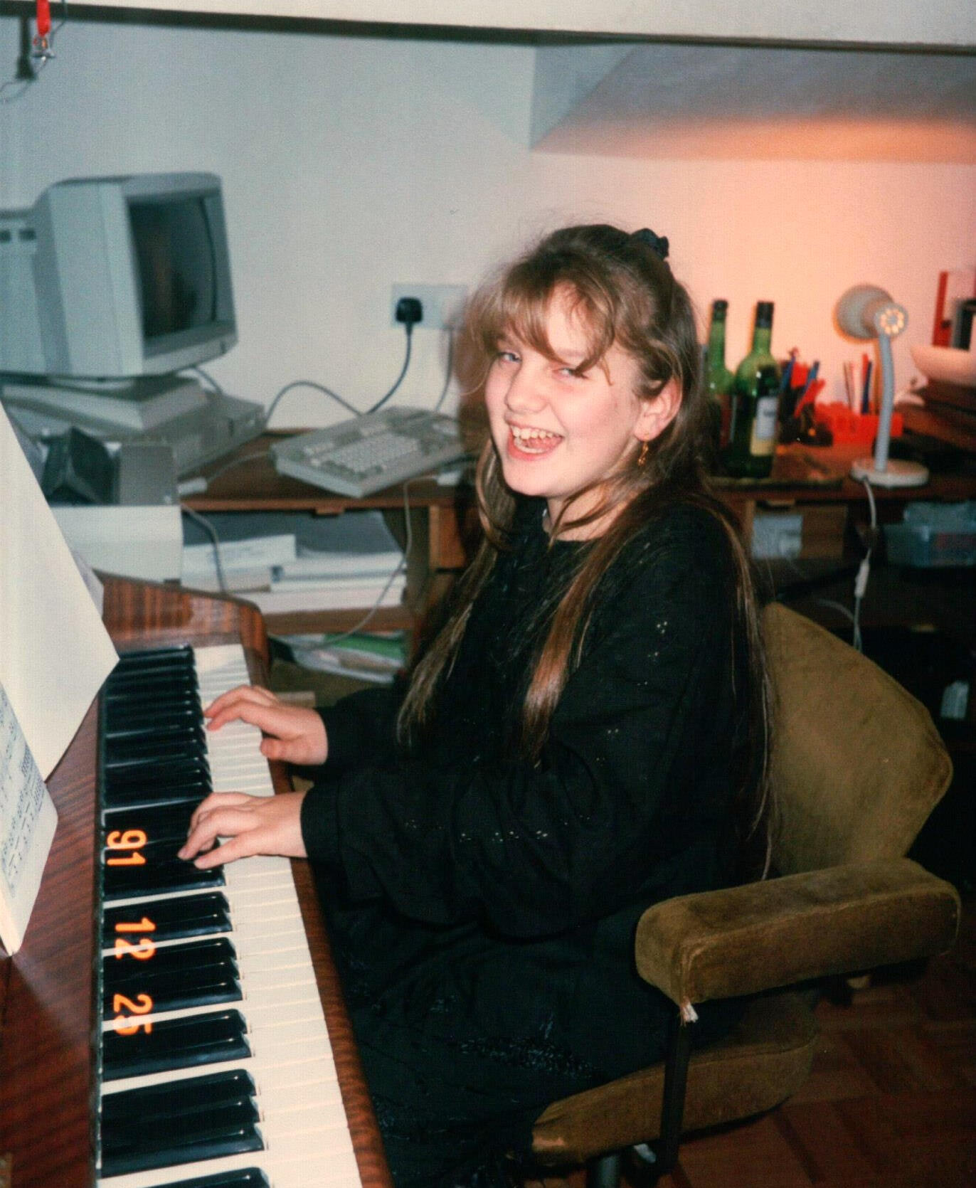 Natasha Koczy as a child, playing piano on Christmas day. Natasha is now a professional musician and music teacher in Saltaire, West Yorkshire